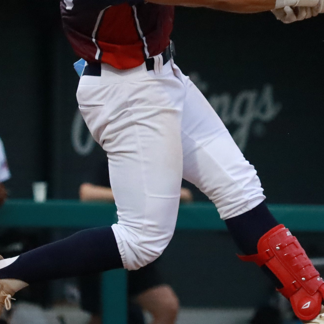 Baseball player in action during a game, swinging a bat with a blurred background.